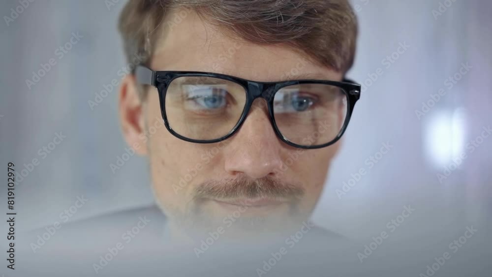 Businessman with glasses looking intently obscured partially by a translucent surface of laptop. Business concept Businessman with glasses looking intently obscured partially by a translucent surface of laptop. Business concept