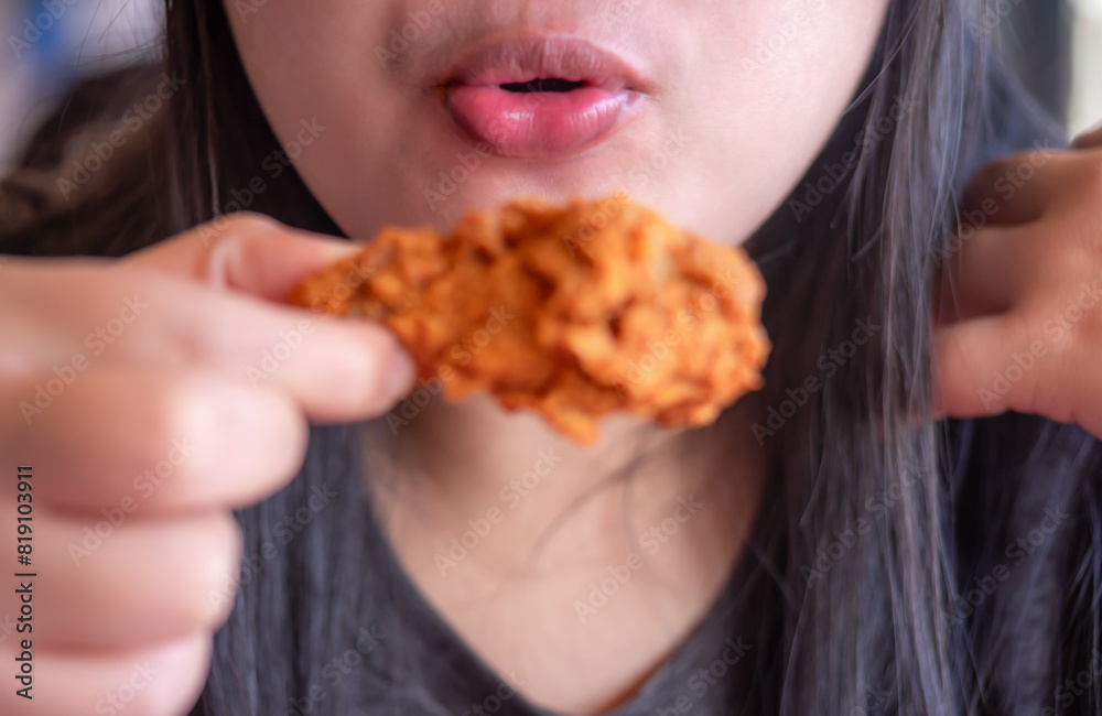 Woman eating fried chicken, Street food in thailand