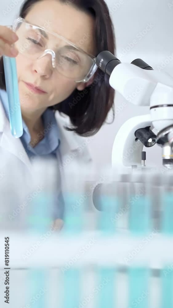 Female scientist analyzing sample in laboratory Female scientist analyzing sample in laboratory