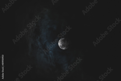 The Moon Shining Through Dark Clouds