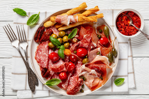italian antipasto plate of cured meat and veggies photo