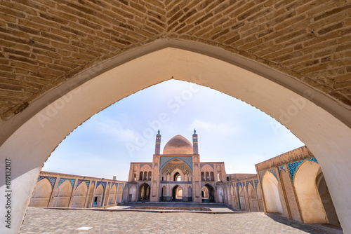 Under a clear sky, a stunning arch outlines the Aga Bozog Mosque. The architectural beauty of Tehran, Iran. photo