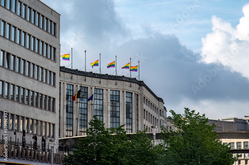 Pride flags waving from the top of a building in Brussels, Belgium