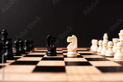 Knight white pawn chess face off with black knight chess black background