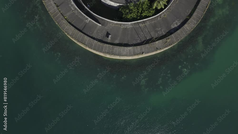 Drone flies over Fort San Marcelo with camera pointing down on the green water in the port of Salvador in Salvador, Bahia, Brazil
