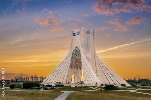 At sunset, locals enjoy a leisurely evening at this iconic landmark in Tehran, the capital of Iran. Azadi Towers, Iran. photo