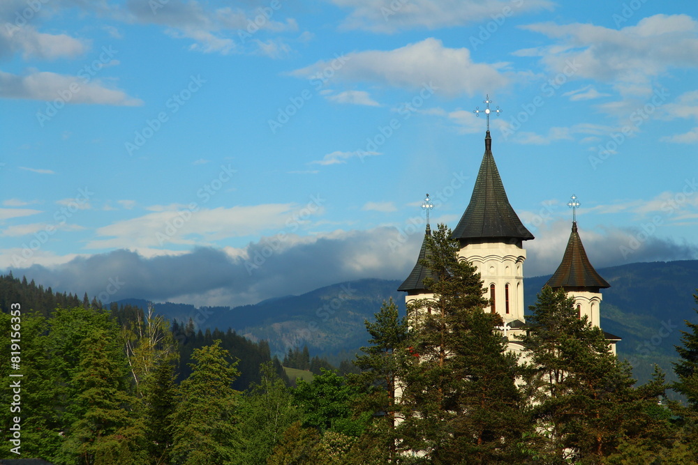 A building with steeples and a cross on top of it A building with steeples and a cross on top of it