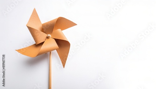 pinwheel or windmill paper origami isolated on white background simple starter craft for kids for weekend entertainment. ESG and Clean Energy Concept. Wind Turbine Paper into the Sky. Decrease Carbon