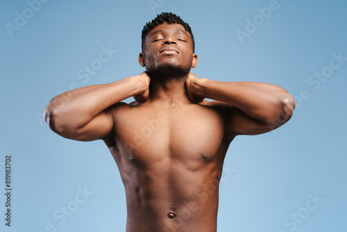 Attractive , sexy, African American man, fashion model touching neck, with closed eyes
