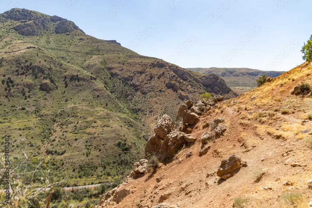 The Solitary Trek: A Lone Hiker Descends a Rocky Mountain Trail The Solitary Trek: A Lone Hiker Descends a Rocky Mountain Trail