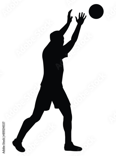 Black silhouette of a man playing volleyball who threw a ball with his arms raised high