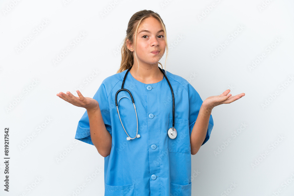 Little caucasian girl disguised as surgeon isolated on white background having doubts while raising hands Little caucasian girl disguised as surgeon isolated on white background having doubts while raising hands
