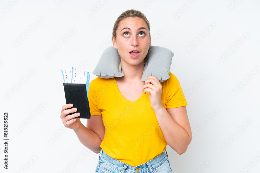 Woman with Inflatable Travel Pillow looking up and with surprised expression Woman with Inflatable Travel Pillow looking up and with surprised expression