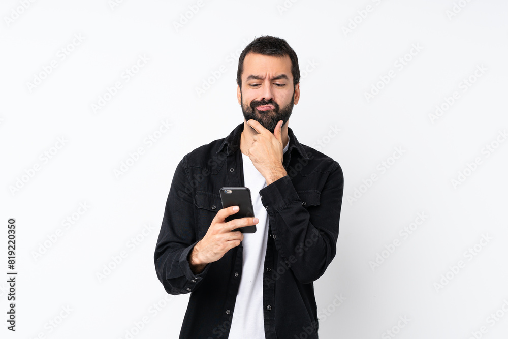 Young man with beard over isolated white background thinking and sending a message Young man with beard over isolated white background thinking and sending a message