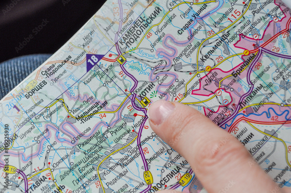 A map and a hand pointing to the town of Khotyn in the Chernivtsi region, Ukraine A map and a hand pointing to the town of Khotyn in the Chernivtsi region, Ukraine