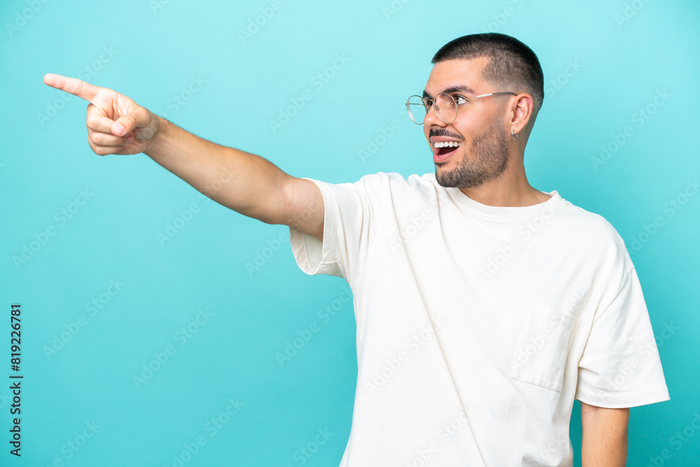 Young caucasian man isolated on blue background pointing away Young caucasian man isolated on blue background pointing away