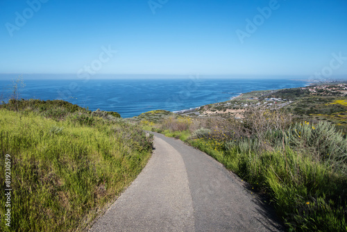 View of the Pacific Ocean from hilltop hiking path at Crystal Cove State Park in Southern California.