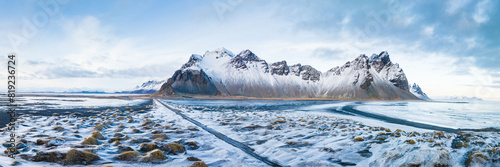 Snow-covered Vestrahorn mountain and icy landscape at Stokksnes beach, South East Iceland photo