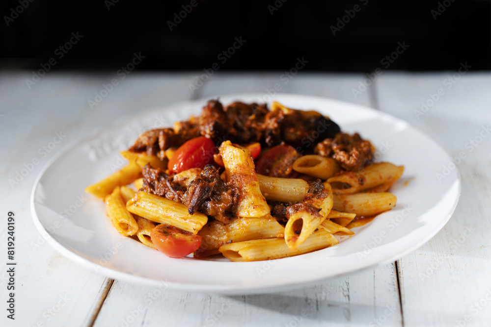 italian penne pasta in oxtail bolognese sauce