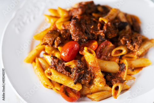 Obraz na płótnie italian penne pasta in oxtail bolognese sauce w salonie