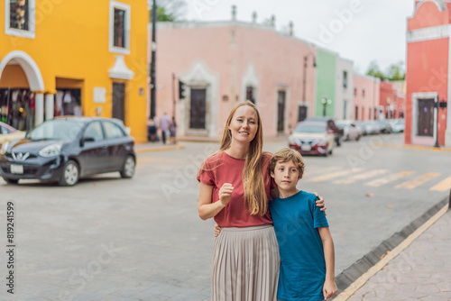 Canvas Print Mother and son tourists explore the vibrant streets of Valladolid, Mexico, immer