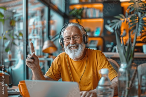 Senior Man Listening to Music on a Laptop