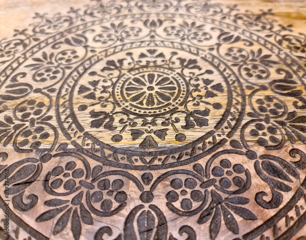 An intricate oriental pattern on a beautiful wooden surface. An intricate oriental pattern on a beautiful wooden surface.