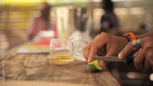 Bartender cutting lime for rum drink/ti punch