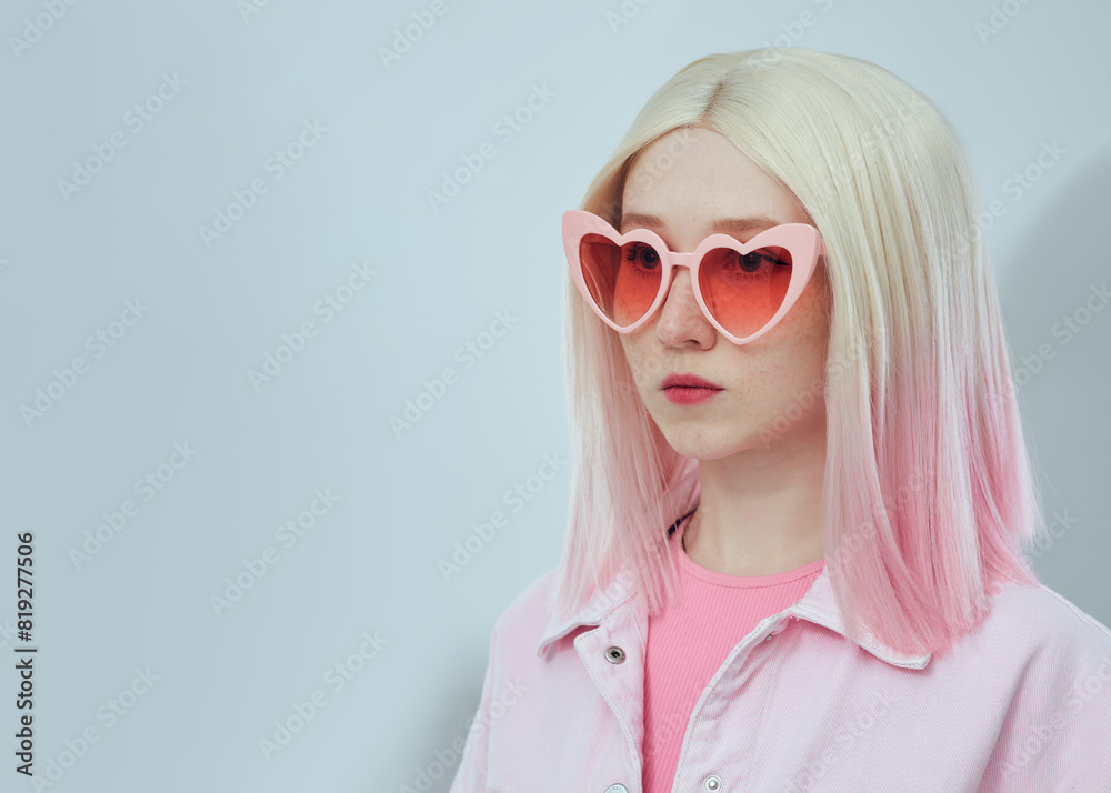 A beautiful woman in a pink vest wearing pink glasses A beautiful woman in a pink vest wearing pink glasses