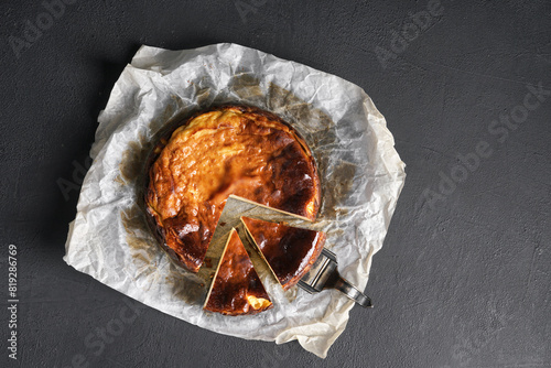 Top view of basque burnt cheesecake liced on black table. copy space photo