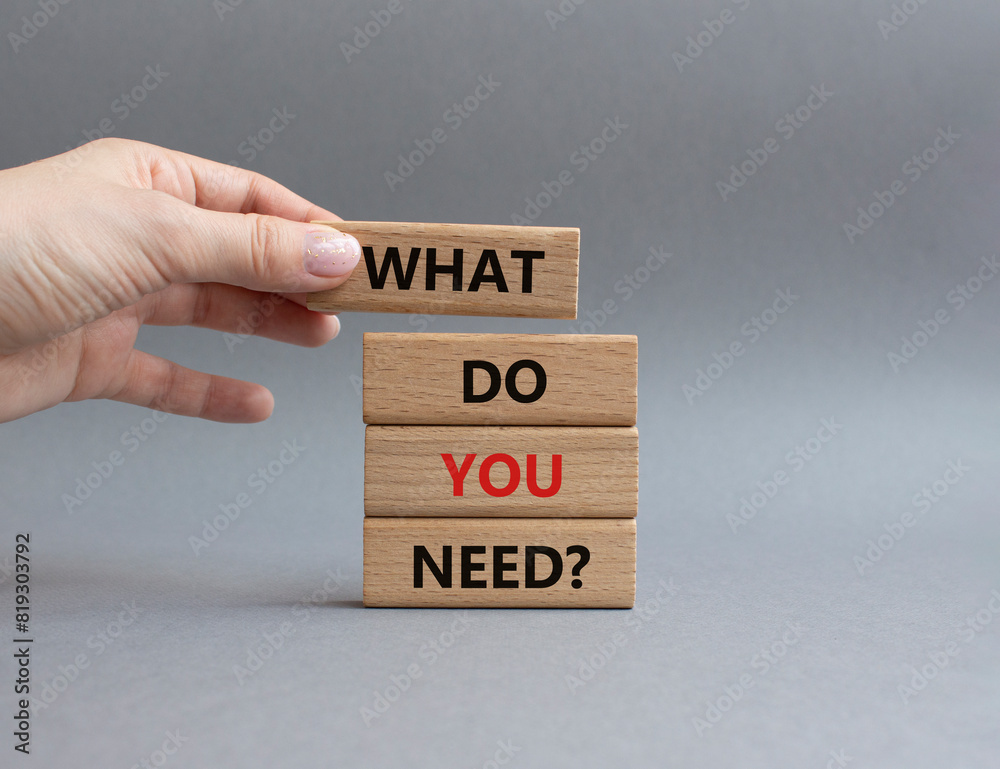 What do you need symbol. Wooden blocks with words What do you need. Businessman hand. Beautiful grey background. Business and What do you need concept. Copy space. What do you need symbol. Wooden blocks with words What do you need. Businessman hand. Beautiful grey background. Business and What do you need concept. Copy space.