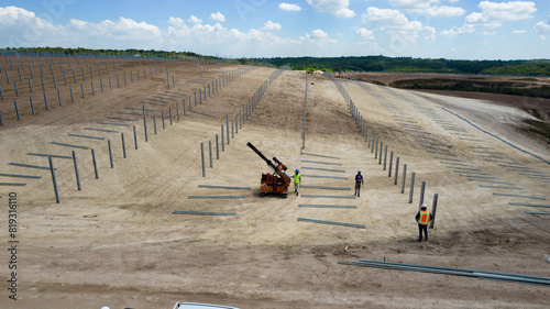Piling machine in solar farm construction during 2024, shot from drone