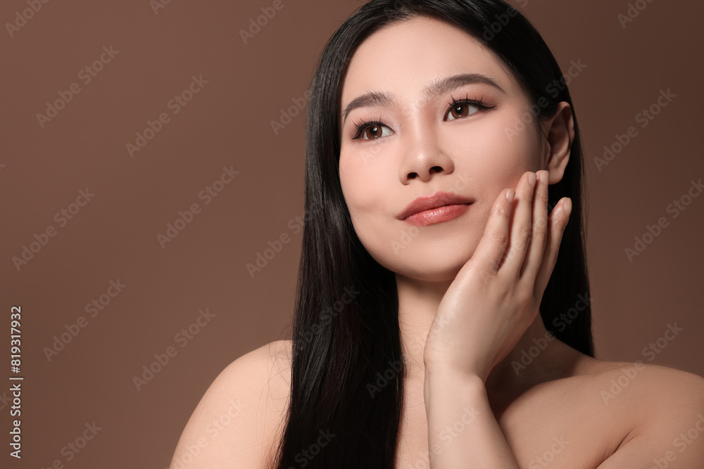 Portrait of beautiful woman on brown background, space for text Portrait of beautiful woman on brown background, space for text