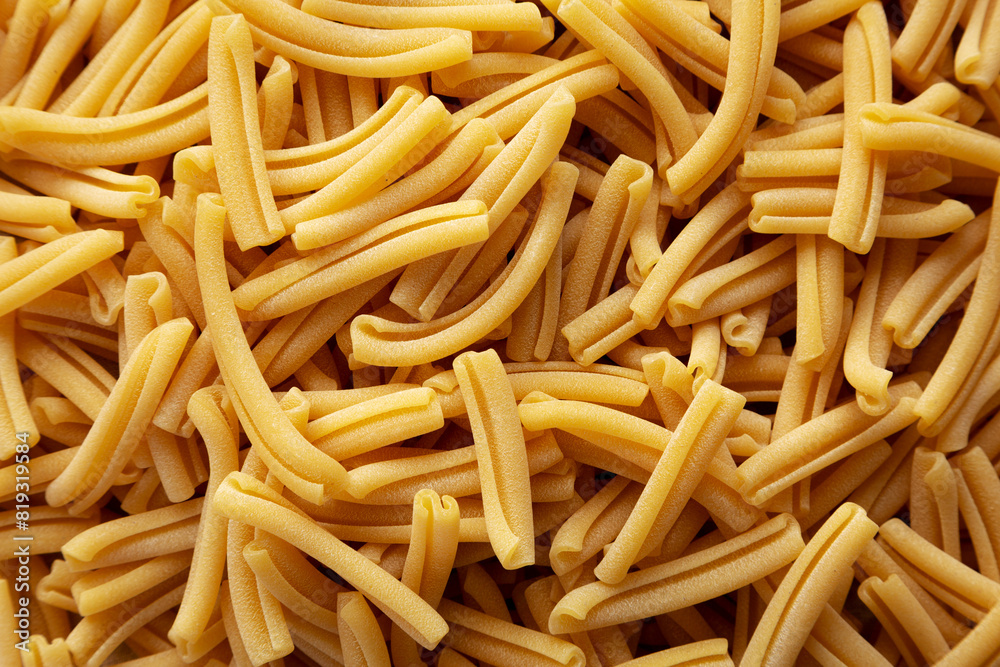 Dry Casarecce Pasta Background, top view. Flat lay, overhead, from above. Dry Casarecce Pasta Background, top view. Flat lay, overhead, from above.