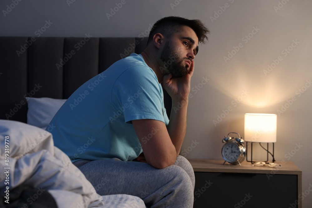 Frustrated man suffering from insomnia on bed Frustrated man suffering from insomnia on bed