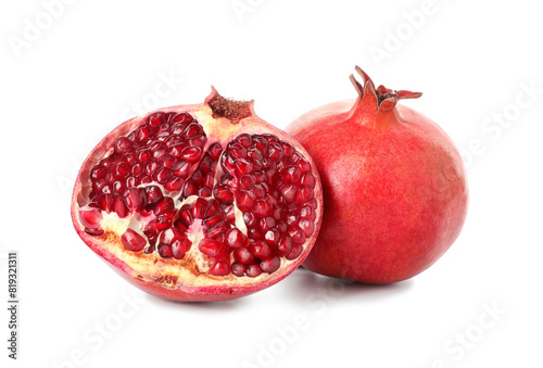Half and whole pomegranates isolated on white