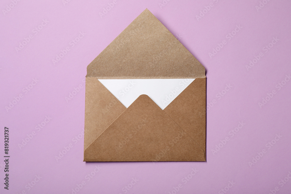 Letter envelope with card on violet background, top view Letter envelope with card on violet background, top view