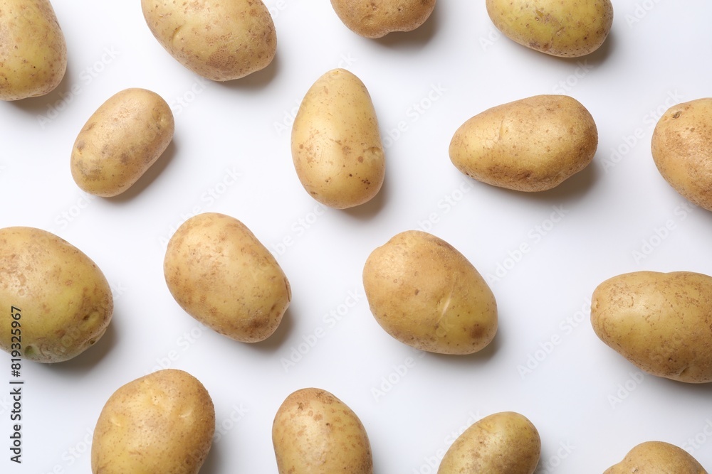 Fresh raw potatoes on white background, flat lay Fresh raw potatoes on white background, flat lay