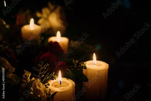 Photo of burning mourning candles on a table against a black background. Lighting candles for bad events  tragedies  in memory  memorial candles  reverence  rest in peace.