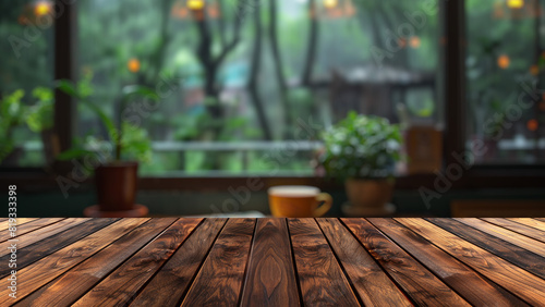 Empty wood table top with blur background of window with home garden view. The table giving copy space for placing advertising product on the table along with beautiful hone window backyard background