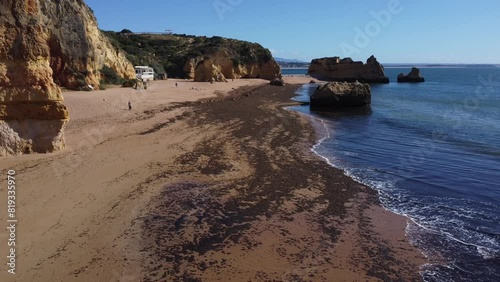 Praia de Dona Ana beach near Lagos town, Algarve, Portugal. Praia Dona Ana beach with turquoise sea water and cliffs, Portugal. Drone aerial view. photo