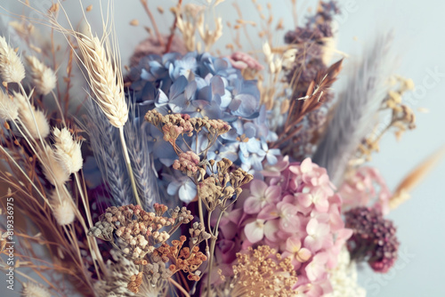 A bouquet of dried flowers. The flowers are a mix of different colors and types, including some blue flowers.