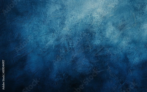 Deep blue textured background with subtle shading and grain. photo