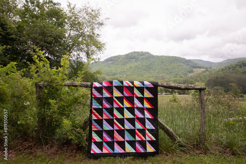 quilt on fence in mountains photo