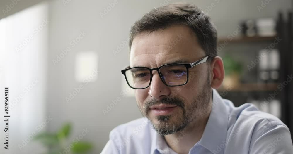 Portrait of successful entrepreneur working using laptop computer, analyzing data, stock market diagram reflecting in glasses. Smiling business owner looking at laptop screen
