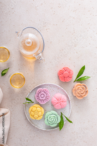 Traditional Chinese snow skin mooncakes for mid autumn festival with fruit, taro and matcha filling photo