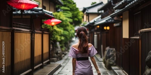 japanese woman walking in the alleys of gion district, kyoto, japan photo