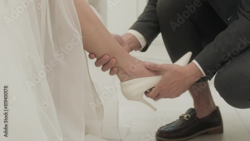 Young Asian couple enjoy preparatation for marriage caremony in fitting room at the bridal store. photo