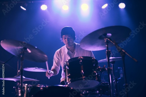 A Japanese drummer is performing on stage during a live music event in Tokyo