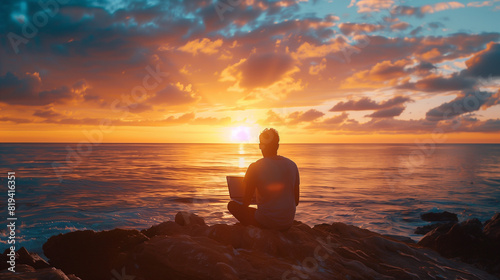 Man Sitting on Rock Watching Sunset